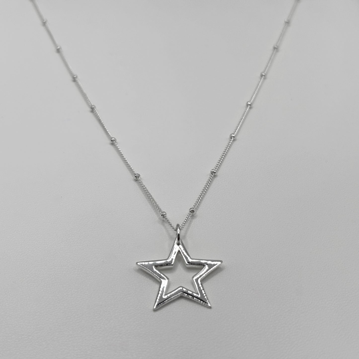 Cut-Out Star Pendant on a Satellite Necklace