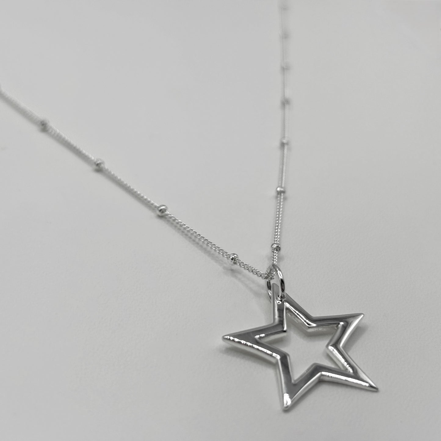 Cut-Out Star Pendant on a Satellite Chain