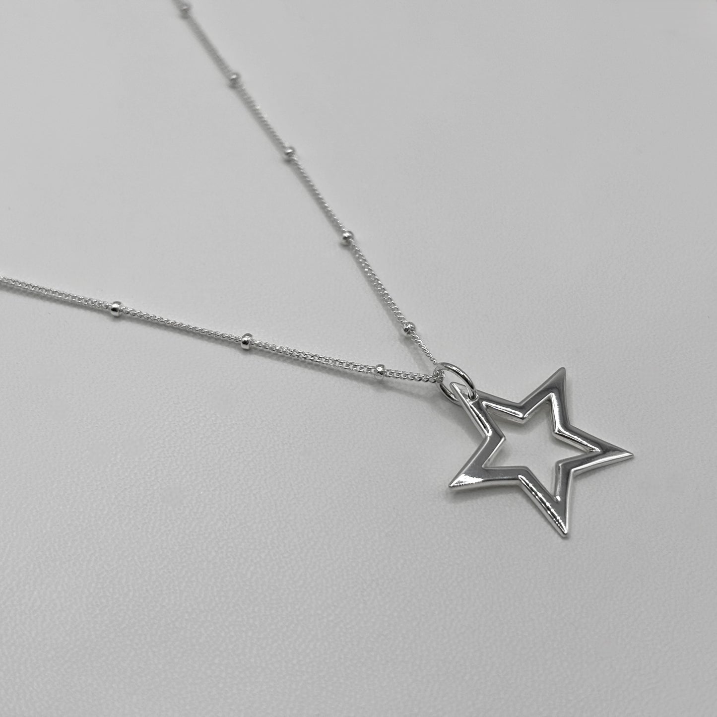 Cut-Out Star Pendant on a Satellite Chain